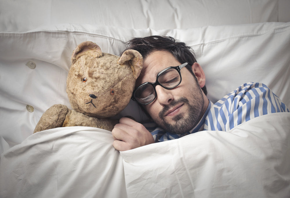 man sleeping with teddy bear